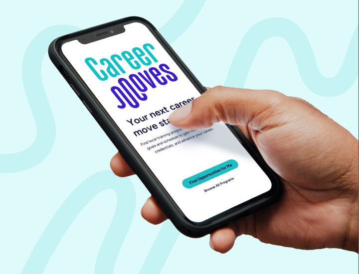 A hand holding a mobile device displaying the Career Moves app. 